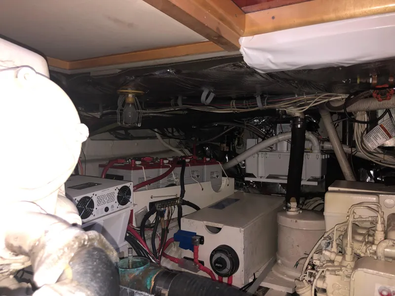 Slide: The Image of Engine room of 1971 Matthews Custom Pilothouse Motor Yacht with visible machinery and wiring. - 48