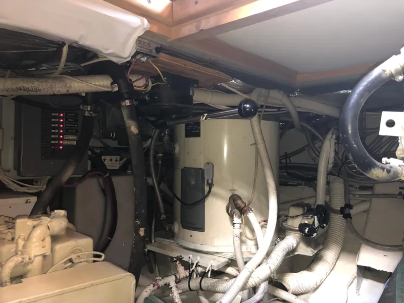 Slide: The Image of Engine room of a 1971 Matthews Custom Pilothouse Motor Yacht with visible machinery and wiring. - 49