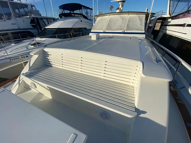 Slide: The Image of 1971 Matthews Custom Pilothouse Motor Yacht with sleek white deck and seating area. - 6