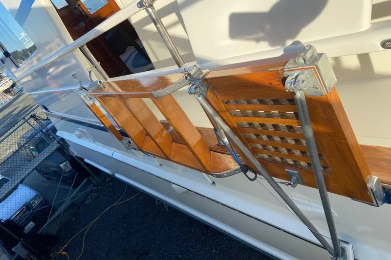 Slide: The Image of 1971 Matthews Custom Pilothouse Motor Yacht with wooden railings and metal supports. - 8