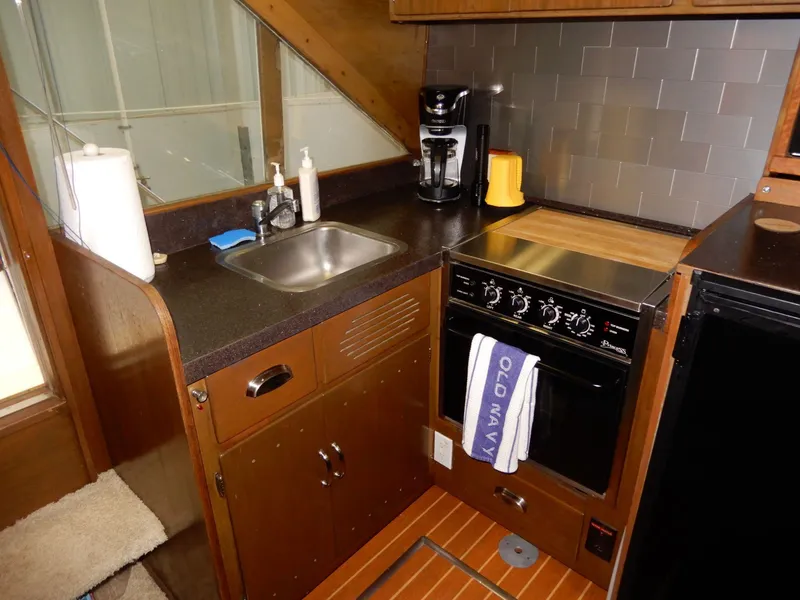 Slide: The Image of 1965 Chris-Craft 38 Constellation kitchen with sink, stove, and coffee maker. - 3