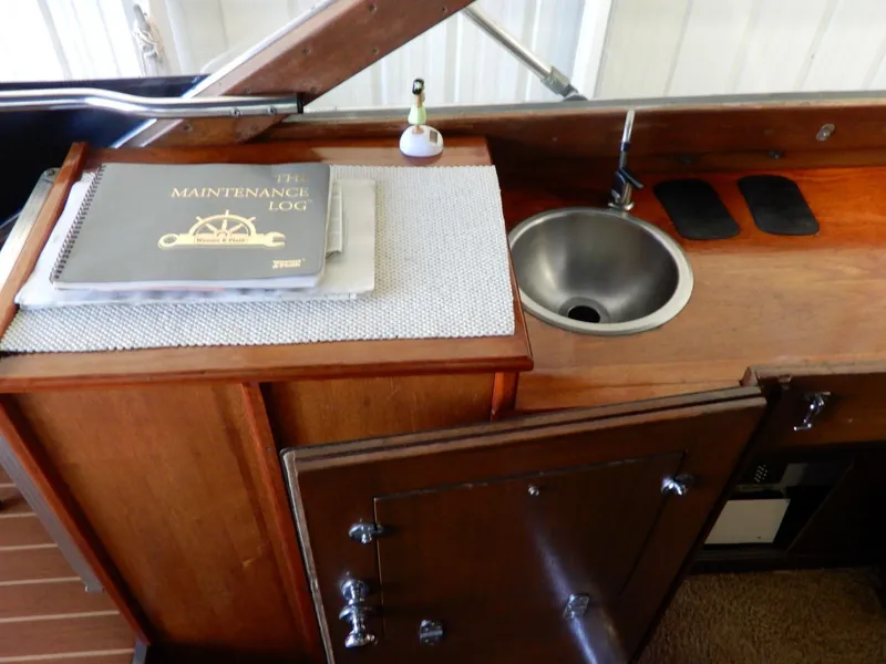 Slide: The Image of 1965 Chris-Craft 38 Constellation interior with maintenance log and sink. - 6