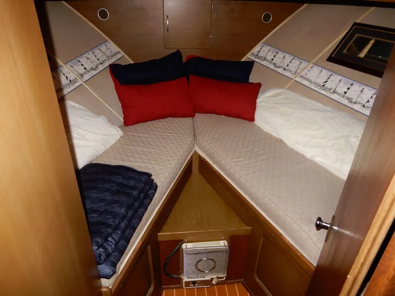 Slide: The Image of 1965 Chris-Craft 38 Constellation cabin with cozy V-berth and colorful pillows. - 7