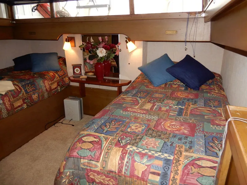 Slide: The Image of Cozy cabin interior of 1965 Chris-Craft 38 Constellation with twin beds and colorful bedding. - 8