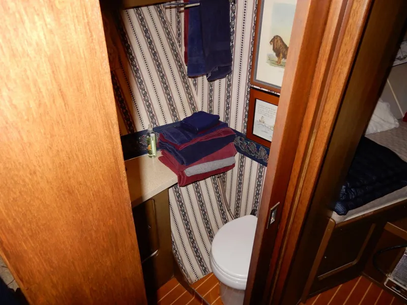 Slide: The Image of 1965 Chris-Craft 38 Constellation bathroom with striped wallpaper and wooden accents. - 9
