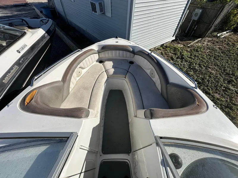 Slide: The Image of 2008 Yamaha Boats SX230 bow seating area with cushioned seats and storage compartments. - 10