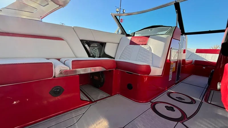 Slide: The Image of 2019 MasterCraft X24 boat interior with red and white seating, sleek design. - 28