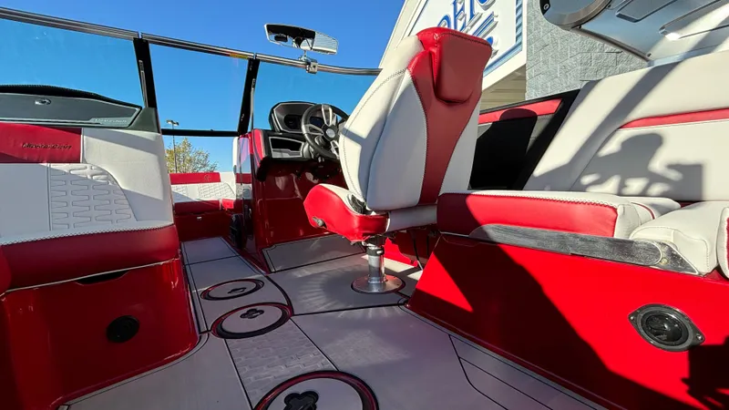 Slide: The Image of 2019 MasterCraft X24 boat interior with red and white seating and modern dashboard. - 29
