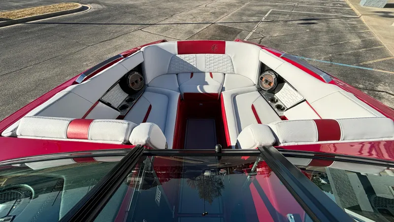 Slide: The Image of 2019 MasterCraft X24 boat interior with red and white seating, speakers, and sleek design. - 39