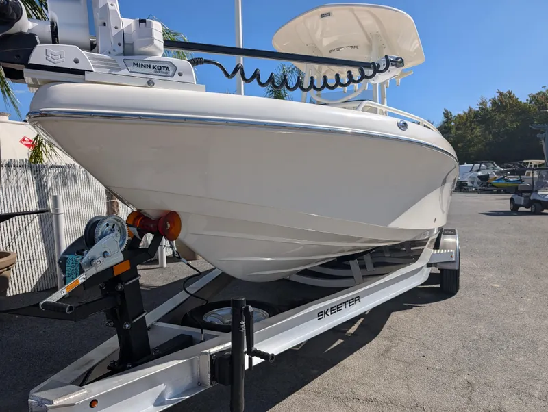 Slide: The Image of 2025 Skeeter SX 2550 Family boat on trailer, featuring sleek white hull design. - 10