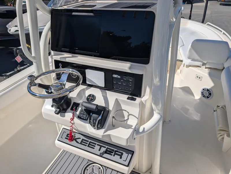 Slide: The Image of 2025 Skeeter SX 2550 Family boat console with steering wheel and controls. - 15