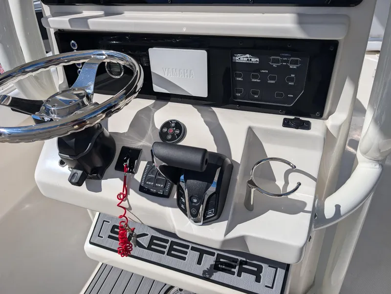 Slide: The Image of 2025 Skeeter SX 2550 Family boat dashboard with steering wheel and controls. - 17