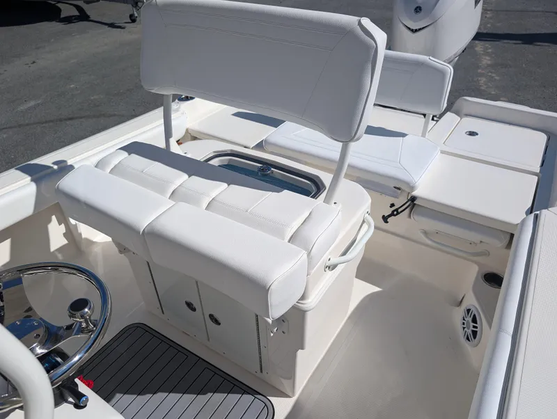 Slide: The Image of 2025 Skeeter SX 2550 Family boat interior with white seating and steering wheel. - 18