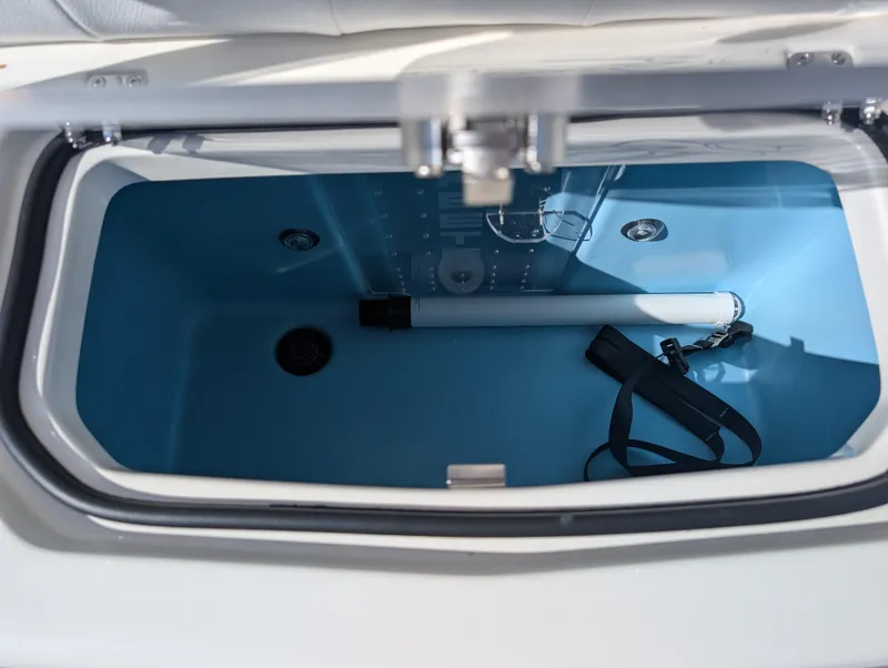 Slide: The Image of 2025 Skeeter SX 2550 Family boat storage compartment, open with blue interior. - 32