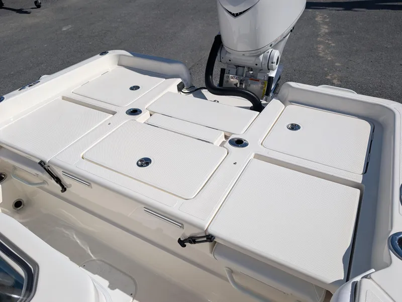 Slide: The Image of 2025 Skeeter SX 2550 Family boat deck with storage compartments and motor. - 33