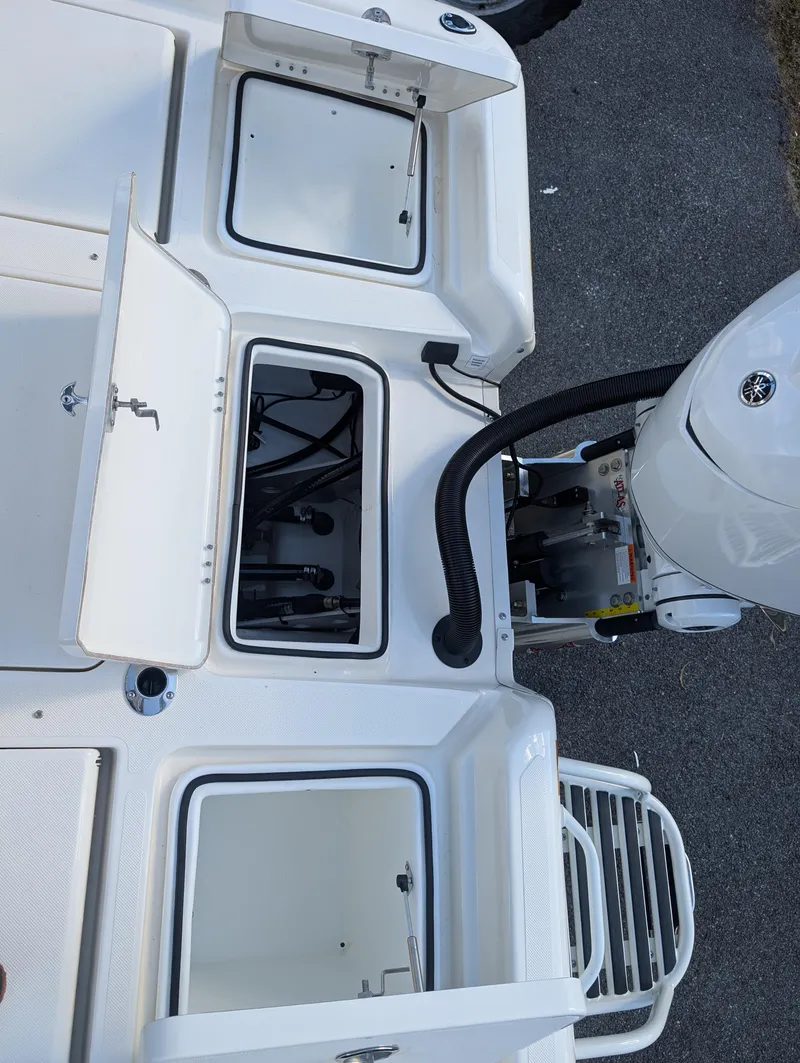 Slide: The Image of 2025 Skeeter SX 2550 Family boat with open storage compartments and motor detail. - 35