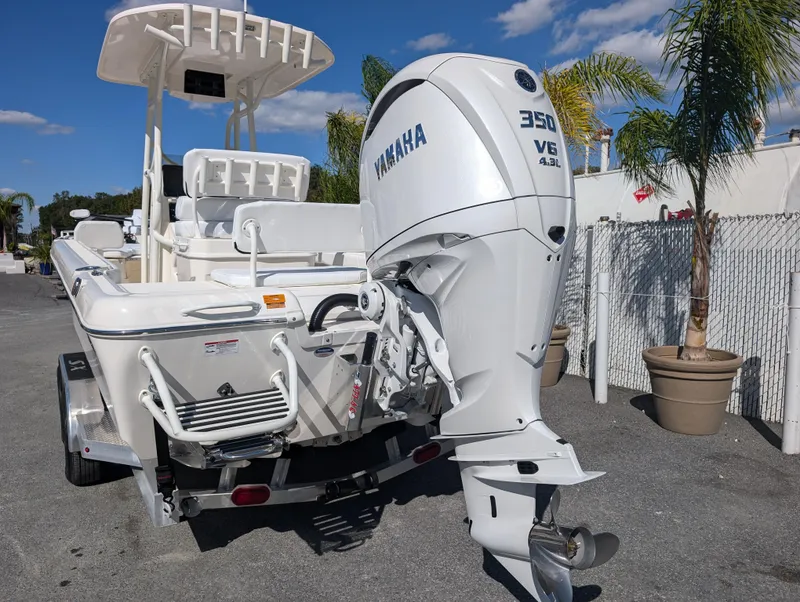 Slide: The Image of 2025 Skeeter SX 2550 Family boat with Yamaha 350 V6 engine, parked outdoors. - 5