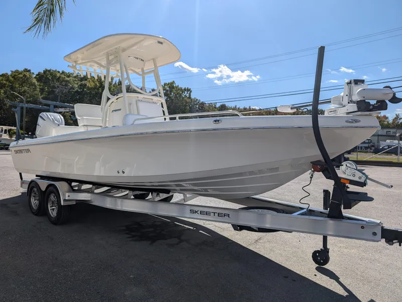 Slide: The Image of 2025 Skeeter SX 2550 Family boat on trailer under clear blue sky. - 8