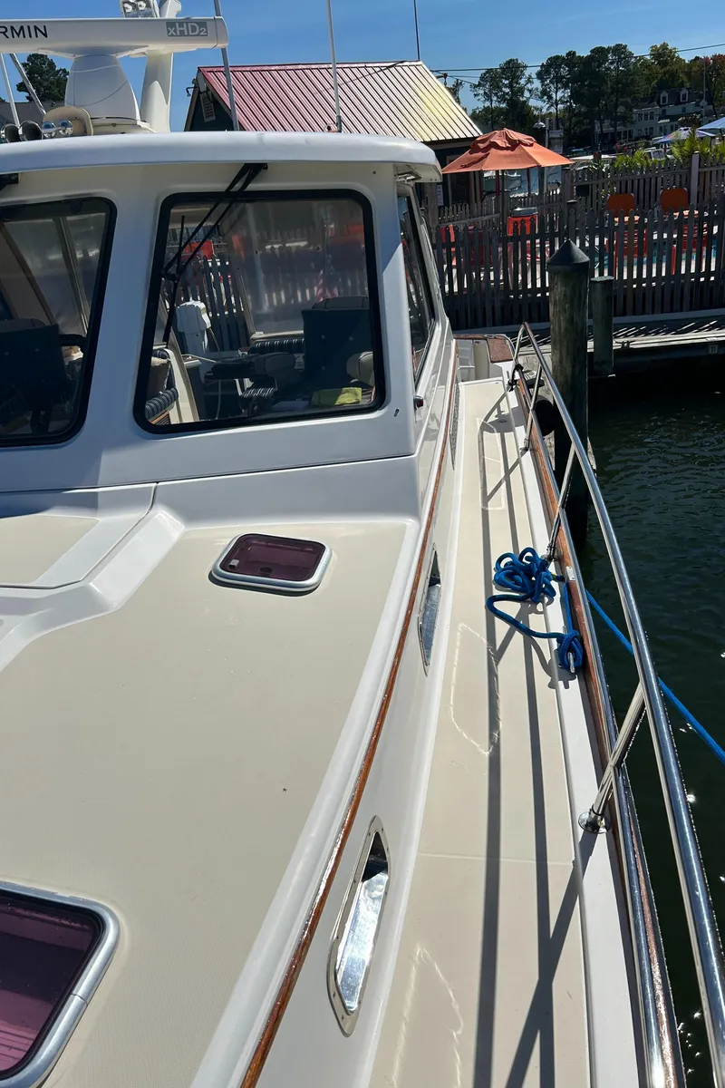 Slide: The Image of 2005 Sabre 42 Hardtop Express yacht docked at marina. - 10