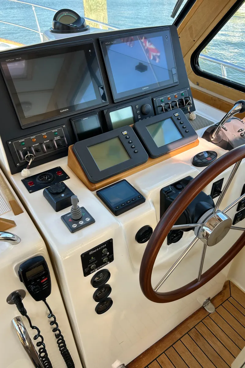 Slide: The Image of 2005 Sabre 42 Hardtop Express helm with navigation screens and controls. - 12