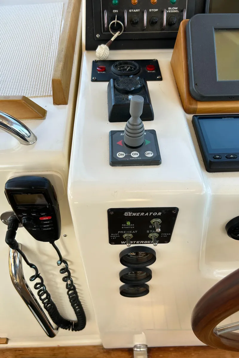 Slide: The Image of Control panel of 2005 Sabre 42 Hardtop Express yacht with joystick and communication device. - 14
