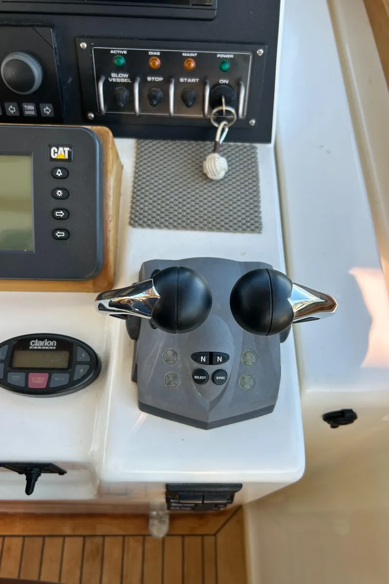Slide: The Image of Control panel of 2005 Sabre 42 Hardtop Express yacht with throttle levers. - 15