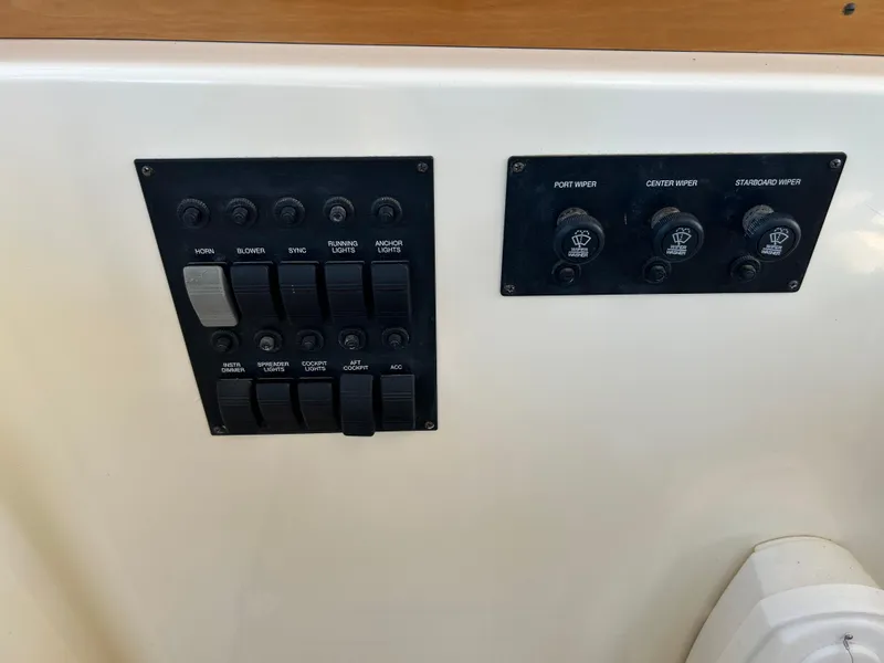 Slide: The Image of Control panel of 2005 Sabre 42 Hardtop Express boat with switches and dials. - 16