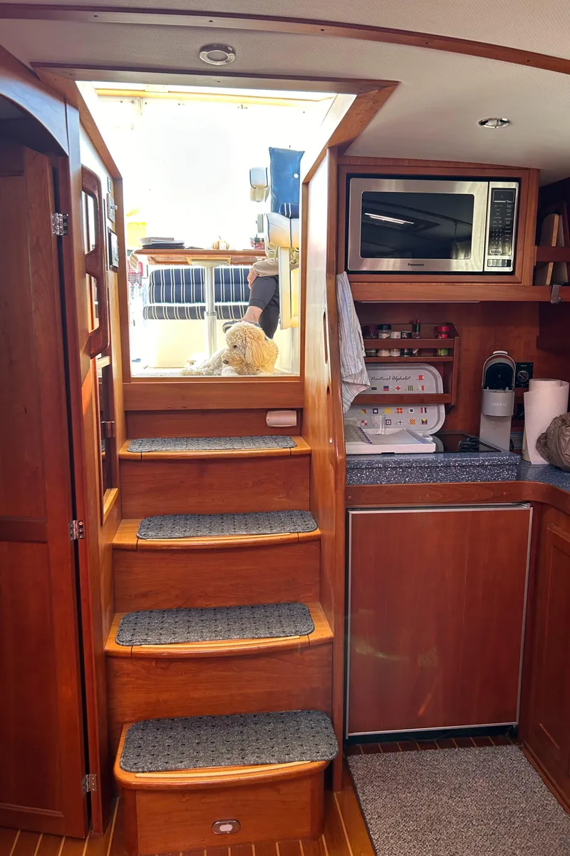 Slide: The Image of Interior of 2005 Sabre 42 Hardtop Express with wooden stairs and kitchenette. - 17