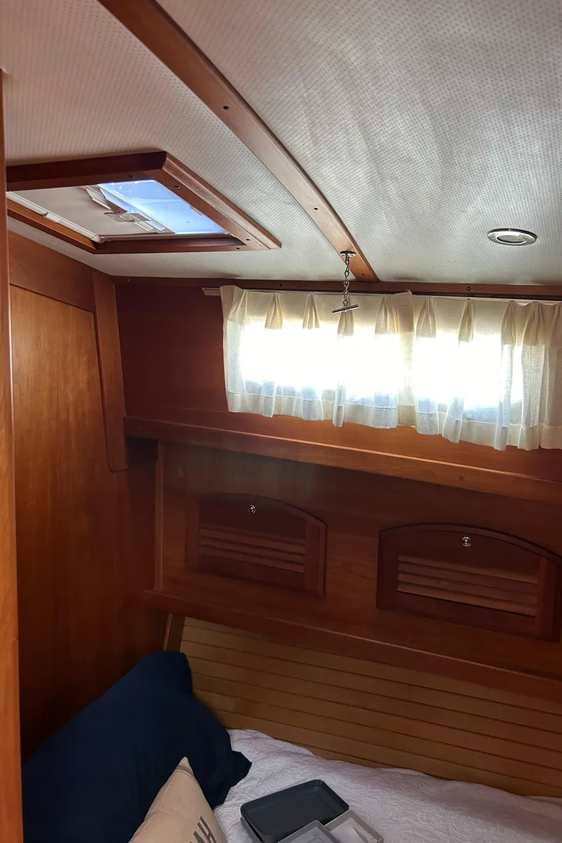 Slide: The Image of Interior cabin of 2005 Sabre 42 Hardtop Express with wooden finish and window. - 29
