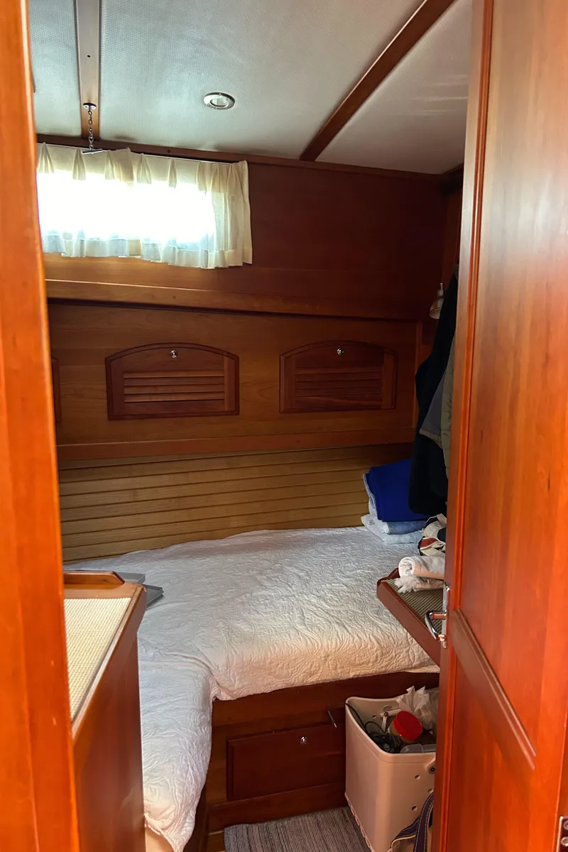Slide: The Image of Cozy cabin interior of 2005 Sabre 42 Hardtop Express yacht with wooden accents. - 30