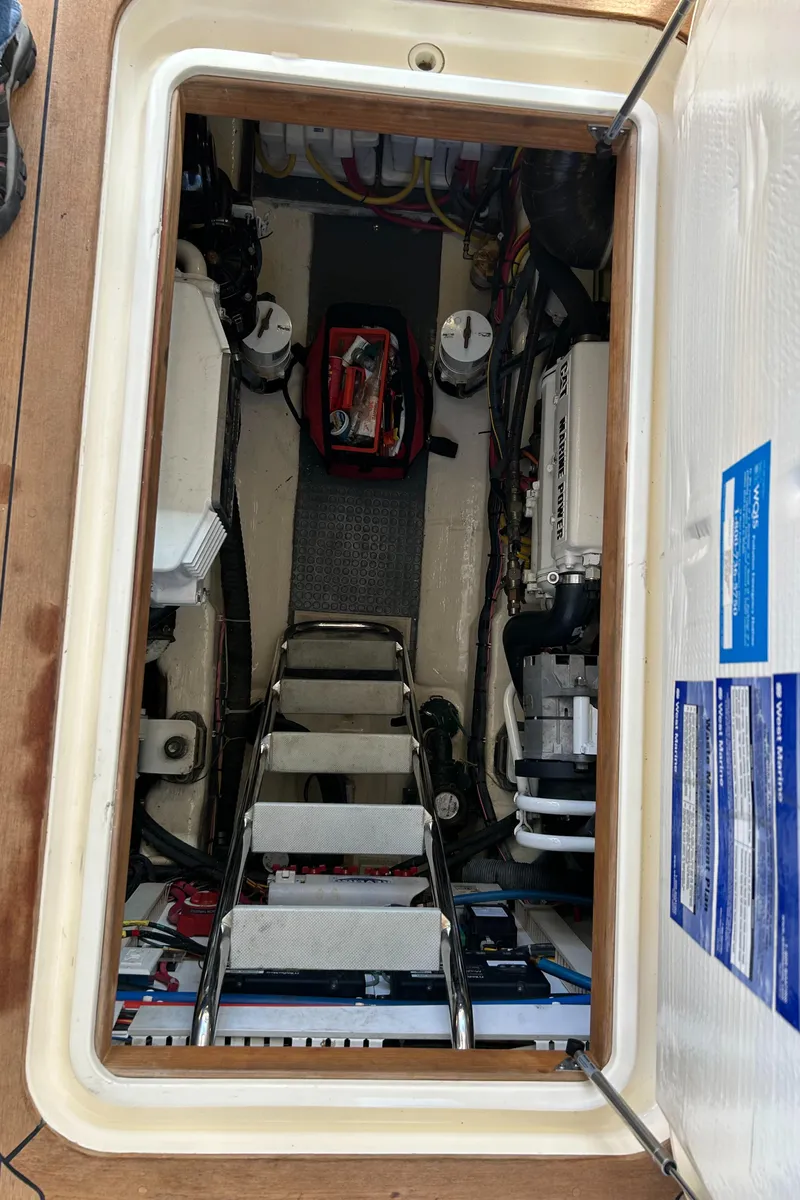 Slide: The Image of Engine compartment of 2005 Sabre 42 Hardtop Express yacht, showing equipment and access ladder. - 31