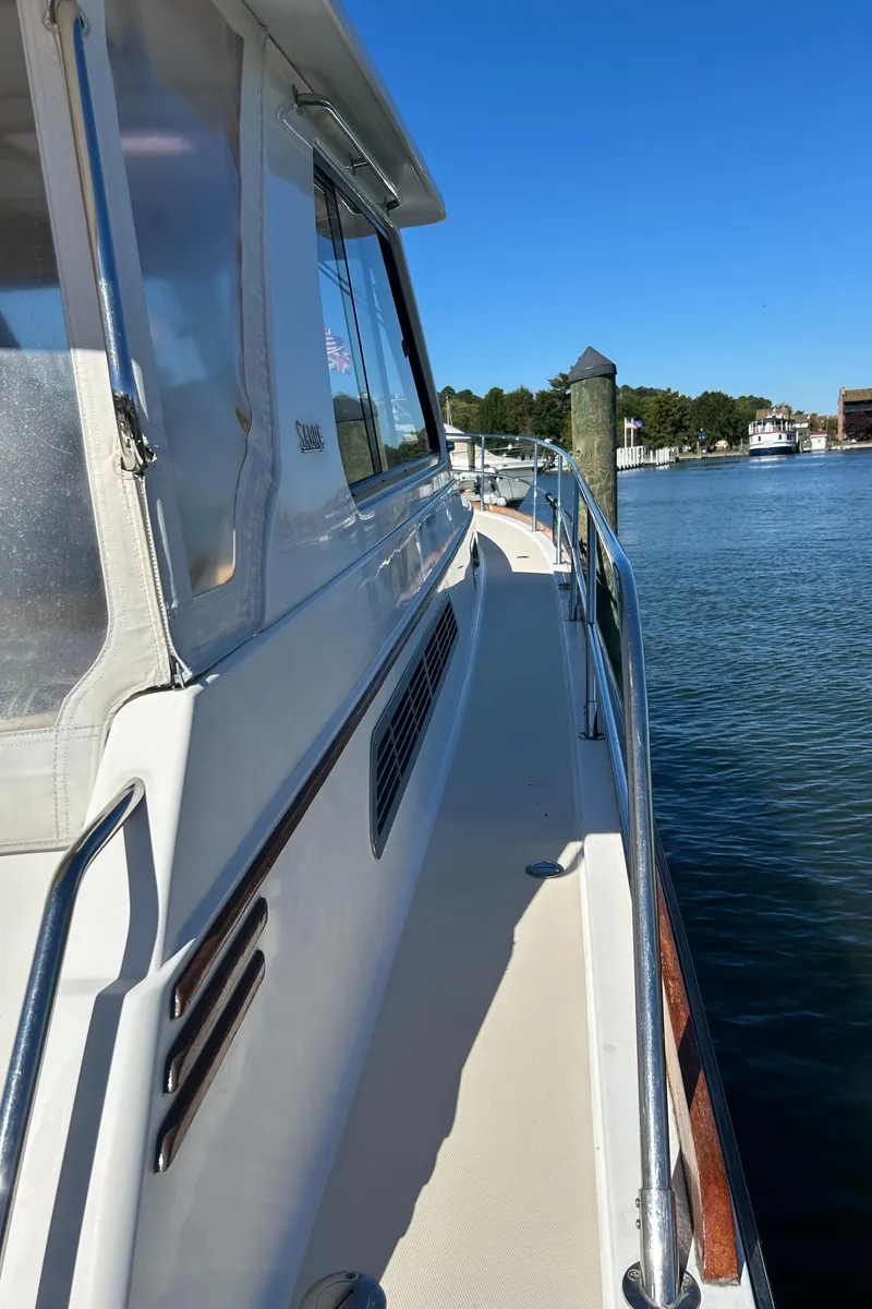Slide: The Image of 2005 Sabre 42 Hardtop Express yacht docked by the water. - 38