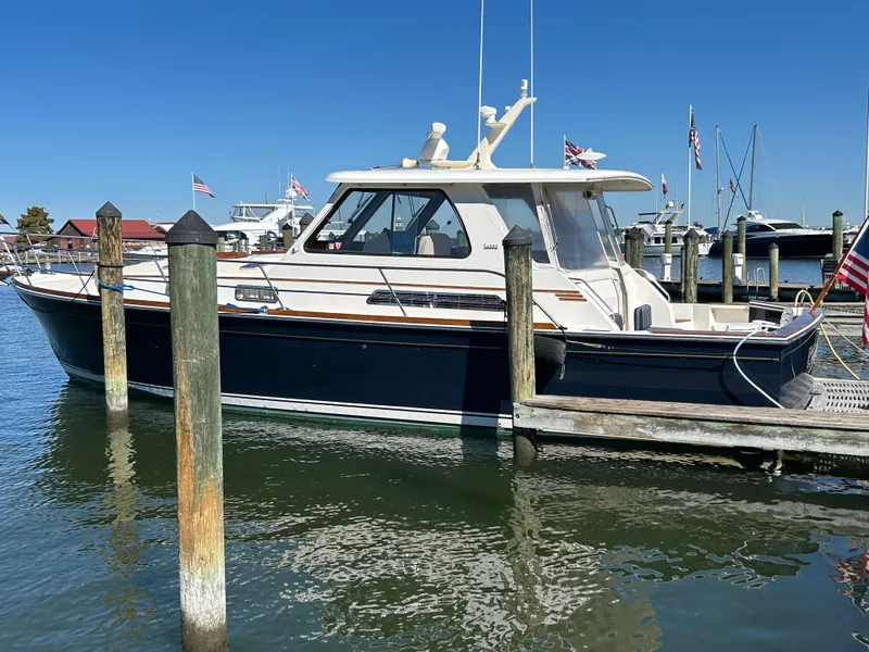Slide: The Image of 2005 Sabre 42 Hardtop Express docked at marina under clear blue sky. - 4