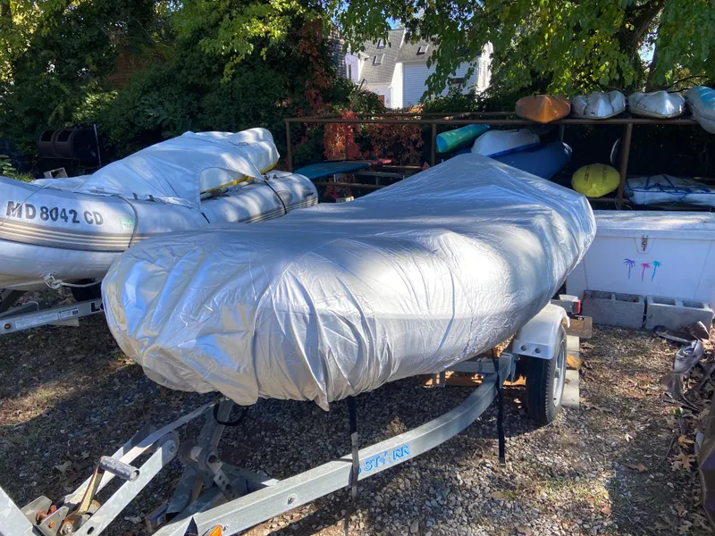 Slide: The Image of Covered boat on trailer, surrounded by trees and other boats. Sabre 42 Hardtop Express, 2005. - 42