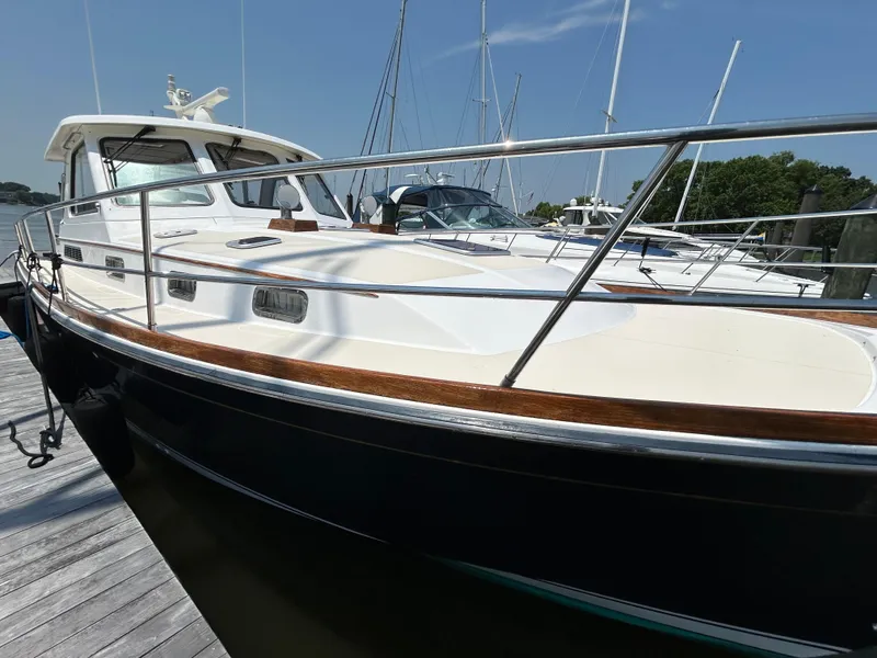 Slide: The Image of 2005 Sabre 42 Hardtop Express yacht docked, showcasing sleek design and polished railings. - 46