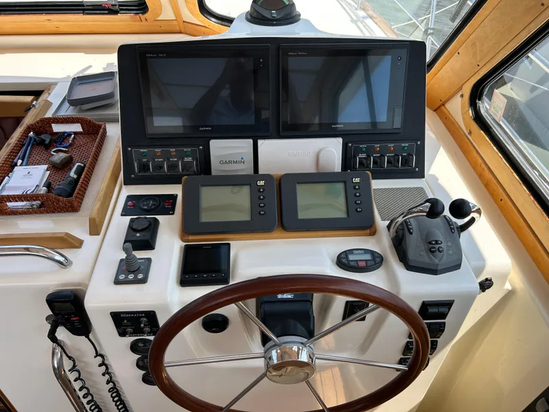 Slide: The Image of 2005 Sabre 42 Hardtop Express helm with navigation screens and controls. - 48