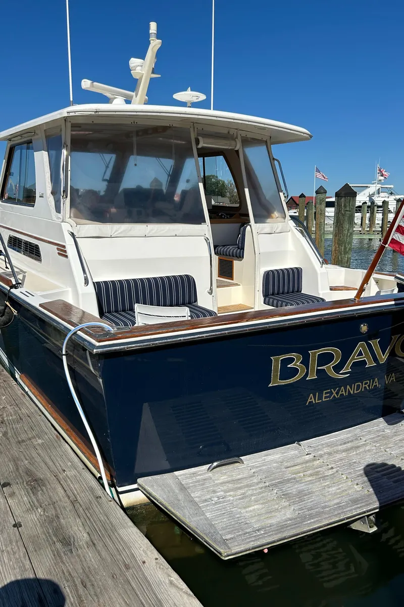Slide: The Image of 2005 Sabre 42 Hardtop Express docked, rear view with "Bravo" name, Alexandria, VA. - 8