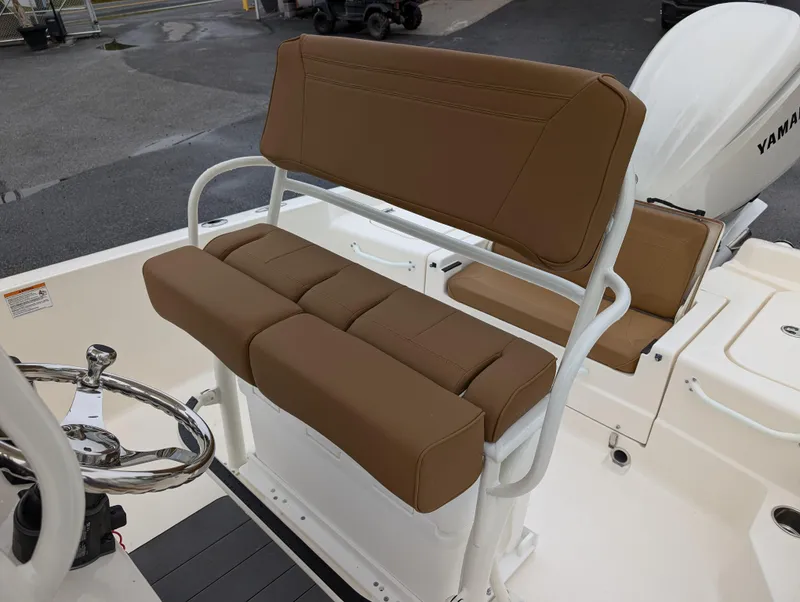 Slide: The Image of 2025 Skeeter SX 2350 boat interior with brown cushioned seating and Yamaha engine. - 14