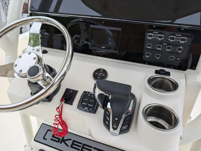 Slide: The Image of 2025 Skeeter SX 2350 boat console with steering wheel, controls, and cup holders. - 17