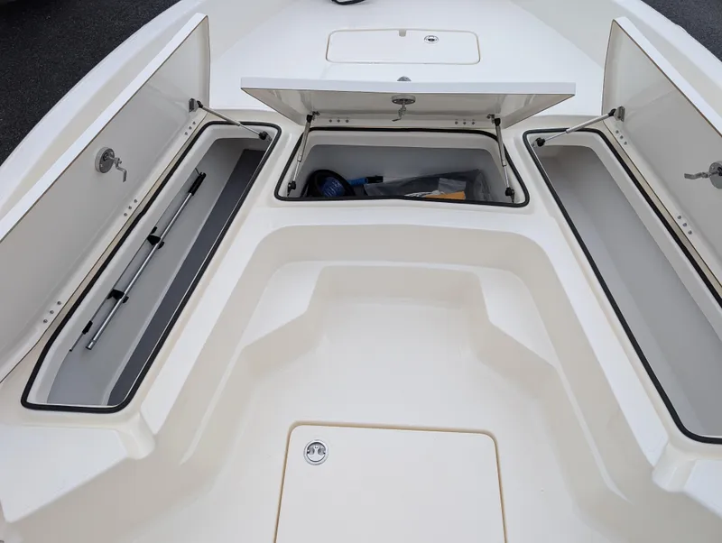 Slide: The Image of 2025 Skeeter SX 2350 boat storage compartments open, showcasing spacious interior design. - 19