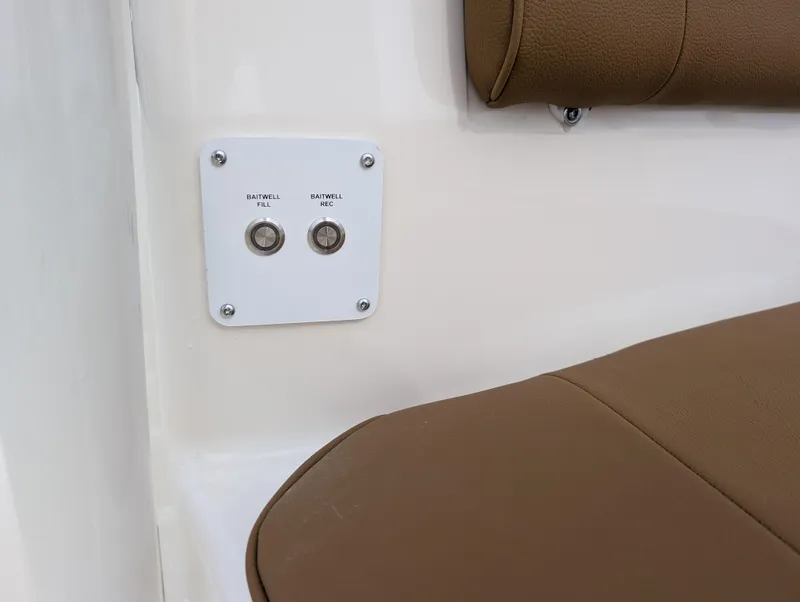 Slide: The Image of 2025 Skeeter SX 2350 boat interior with brown seating and control panel. - 20