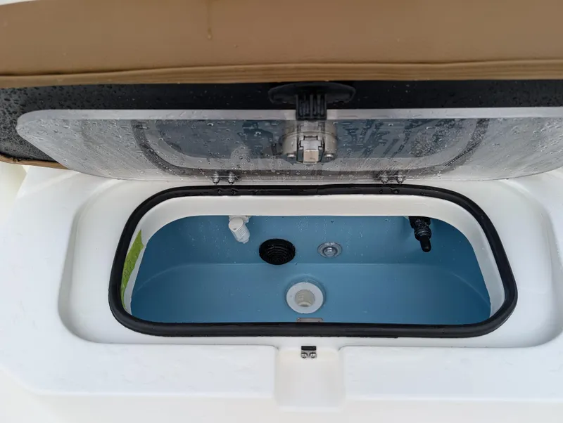 Slide: The Image of 2025 Skeeter SX 2350 boat livewell with open lid, showcasing interior design. - 21