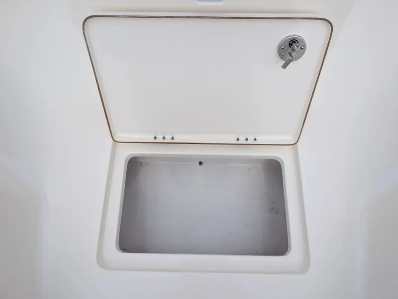 Slide: The Image of 2025 Skeeter SX 2350 boat storage compartment with open lid. - 22