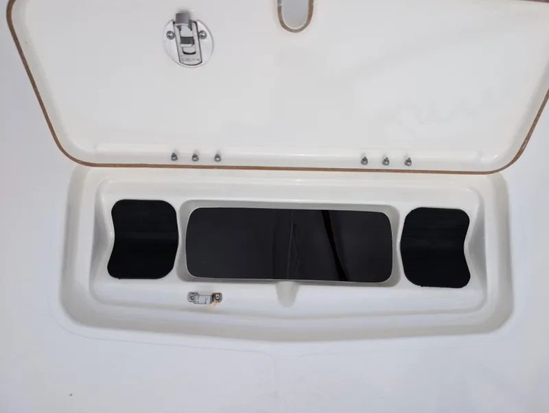 Slide: The Image of Open storage compartment on 2025 Skeeter SX 2350 boat. - 25