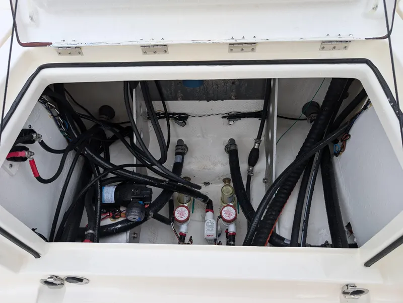Slide: The Image of Open compartment of 2025 Skeeter SX 2350 boat showing wiring and components. - 28
