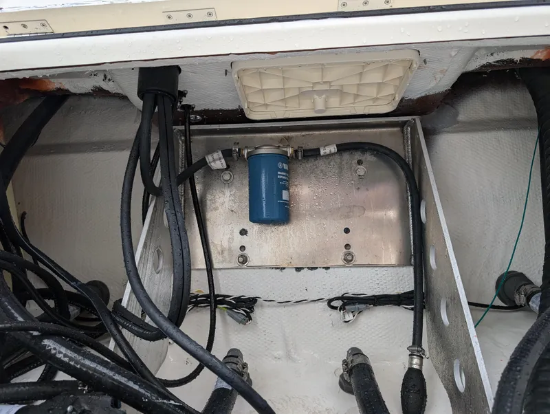 Slide: The Image of 2025 Skeeter SX 2350 boat wiring and filter system in compartment. - 29