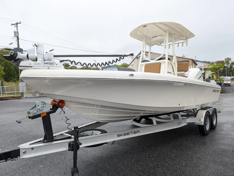 Slide: The Image of 2025 Skeeter SX 2350 boat on trailer, white exterior, parked outdoors. - 3