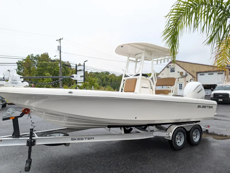 Slide: The Image of 2025 Skeeter SX 2350 boat on trailer, parked outdoors near palm tree. - 4