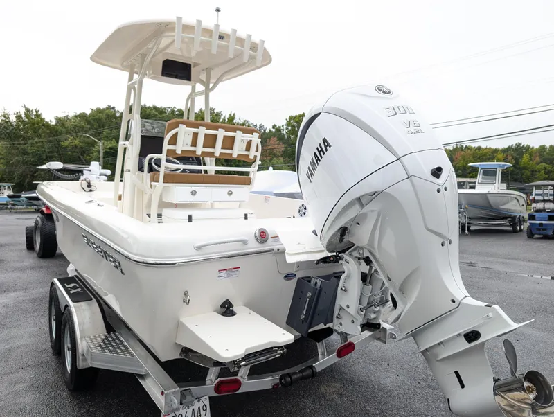 Slide: The Image of 2025 Skeeter SX 2350 boat with Yamaha engine on trailer, parked outdoors. - 6