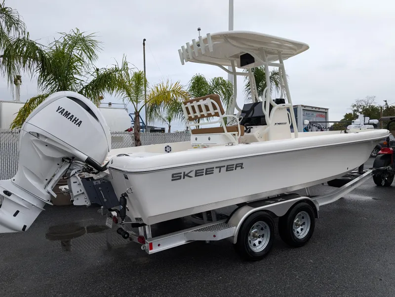 Slide: The Image of 2025 Skeeter SX 2350 boat with Yamaha engine on trailer, parked near palm trees. - 8